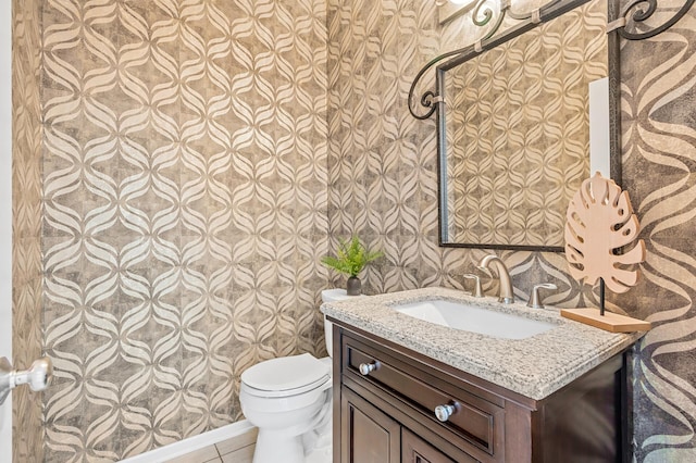 bathroom with tile patterned floors, toilet, and vanity