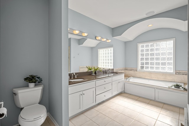 full bathroom featuring tile patterned flooring, double vanity, toilet, and a sink