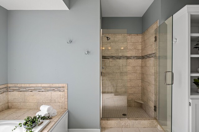 full bathroom featuring a bath and a shower stall