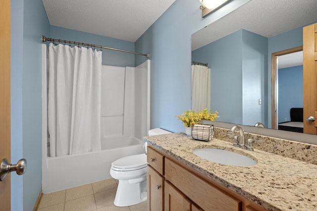 bathroom featuring tile patterned flooring, toilet, shower / tub combo with curtain, vanity, and a textured ceiling