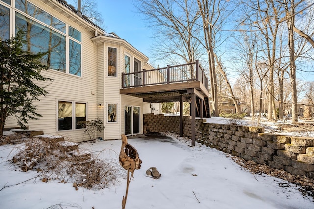 exterior space featuring a fire pit and a wooden deck