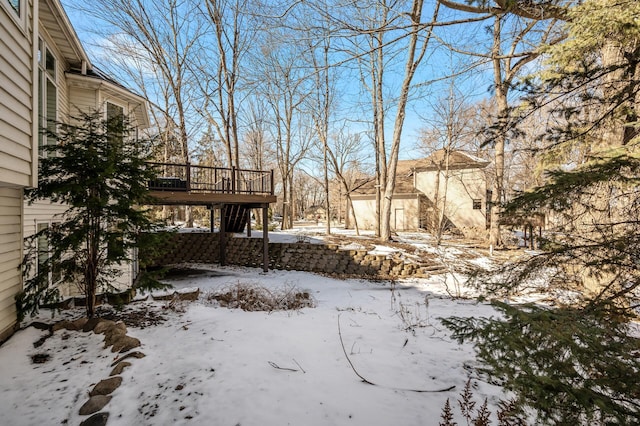 snowy yard featuring a deck