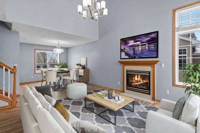 living room featuring light hardwood / wood-style flooring and a notable chandelier