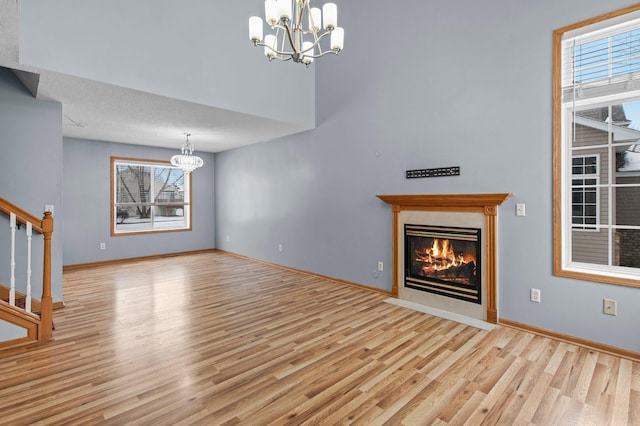 unfurnished living room featuring light hardwood / wood-style floors and a chandelier