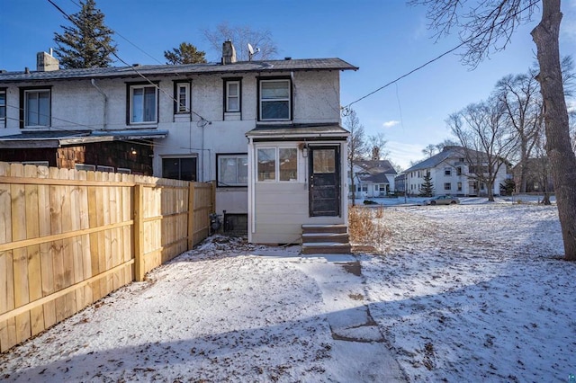 view of front of home with entry steps and fence