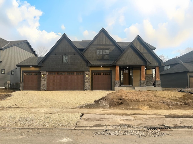 craftsman inspired home featuring a porch, central AC, and dirt driveway