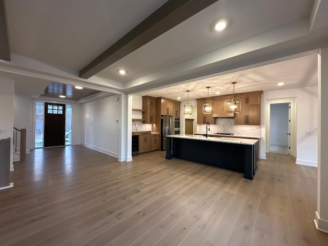 kitchen with beverage cooler, open floor plan, light countertops, stainless steel refrigerator with ice dispenser, and open shelves