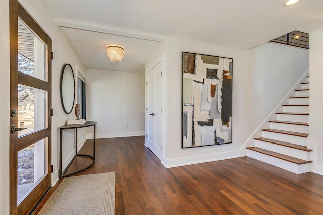 interior space featuring stairway, wood finished floors, and baseboards