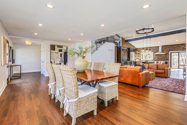 dining space featuring stairway, vaulted ceiling, recessed lighting, wood finished floors, and a notable chandelier