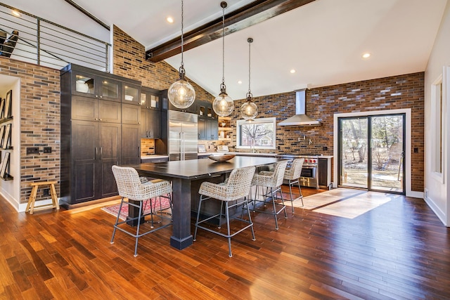 dining space with dark wood-style floors, beamed ceiling, brick wall, and high vaulted ceiling