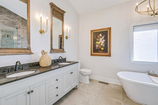 bathroom featuring a sink, a stall shower, double vanity, and tile patterned flooring