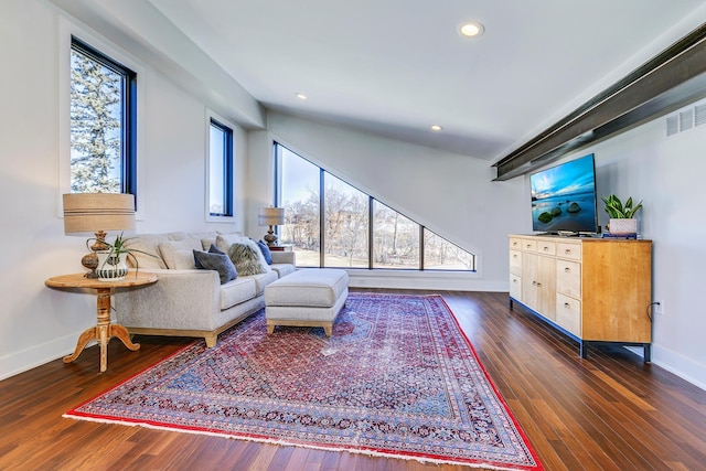 living area featuring recessed lighting, visible vents, baseboards, and dark wood finished floors