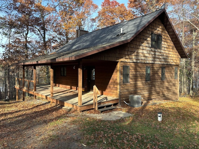 exterior space with cooling unit and a wooden deck