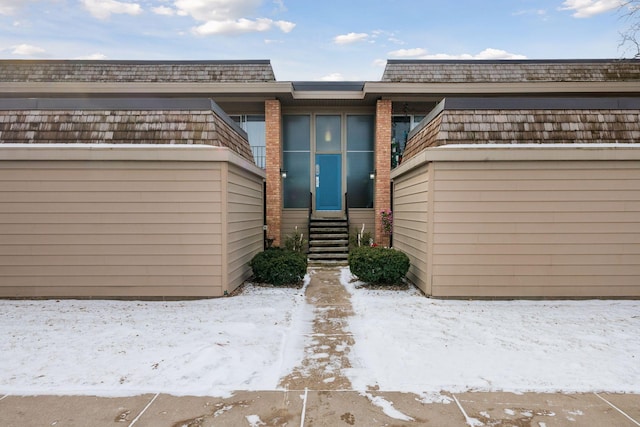 exterior space with entry steps and a balcony