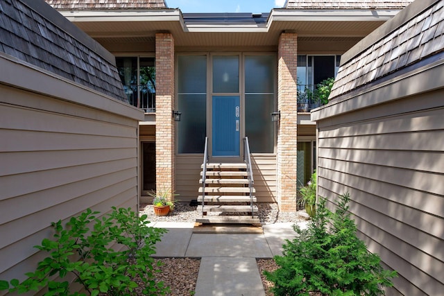 property entrance featuring brick siding