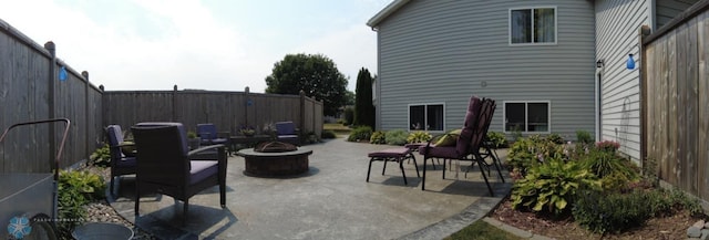 view of patio featuring an outdoor fire pit and a fenced backyard