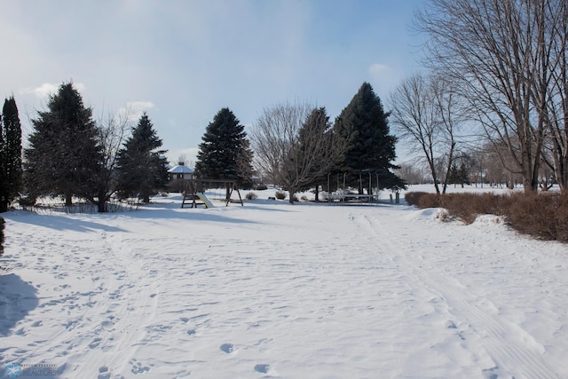 snowy yard featuring playground community