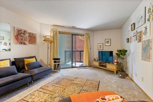 carpeted living area featuring a textured ceiling