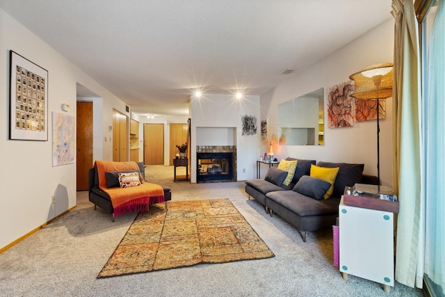 living room with carpet flooring and a tiled fireplace