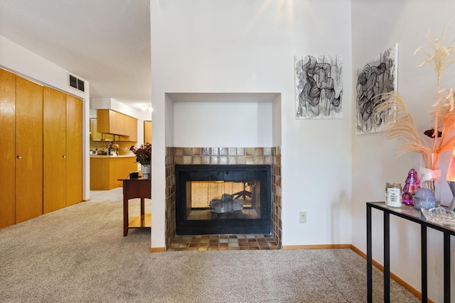 living area featuring carpet flooring, a fireplace, and baseboards