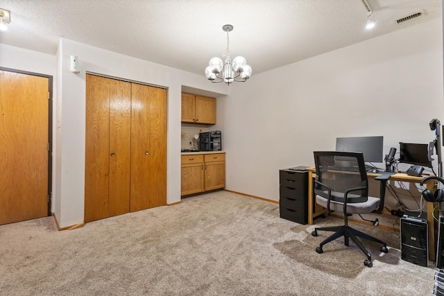 office area featuring light carpet and a chandelier