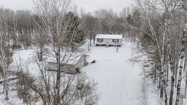 snowy aerial view with a view of trees