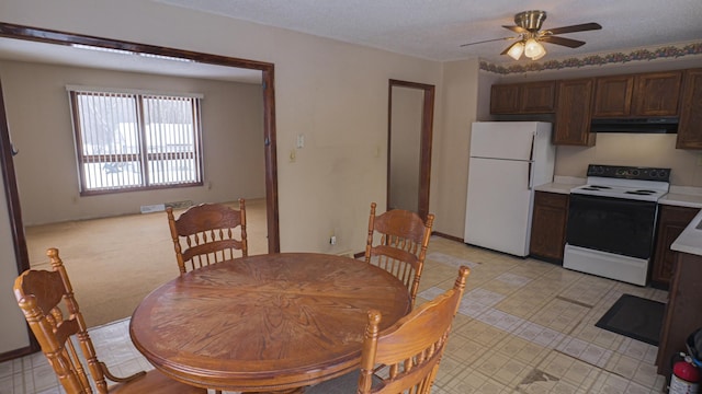 dining space with a ceiling fan and a textured ceiling