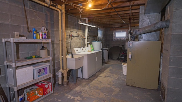 below grade area featuring water heater and independent washer and dryer