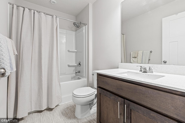 full bath with shower / bath combo, vanity, and toilet