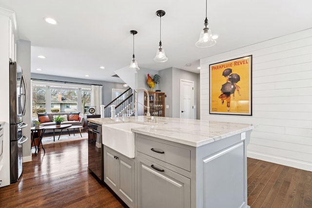 kitchen with dishwasher, dark wood-style floors, light stone countertops, pendant lighting, and recessed lighting