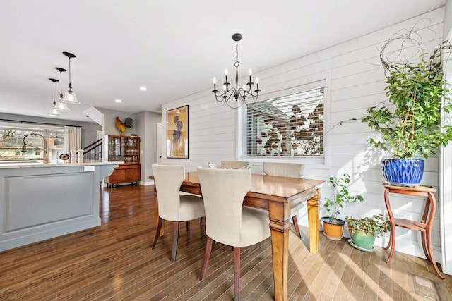 dining room with recessed lighting, dark wood-style flooring, and an inviting chandelier