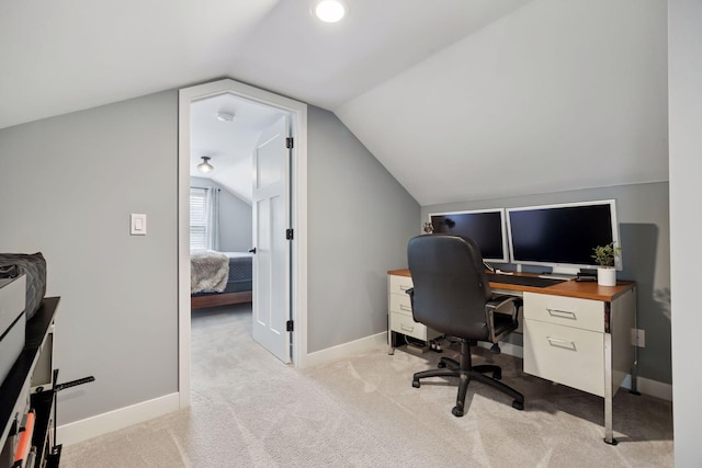 home office featuring vaulted ceiling, baseboards, and light colored carpet