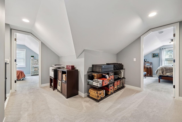 additional living space with carpet floors, a wealth of natural light, vaulted ceiling, and baseboards