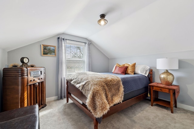 bedroom featuring light carpet, vaulted ceiling, and baseboards