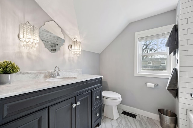 bathroom with toilet, vanity, visible vents, vaulted ceiling, and baseboards