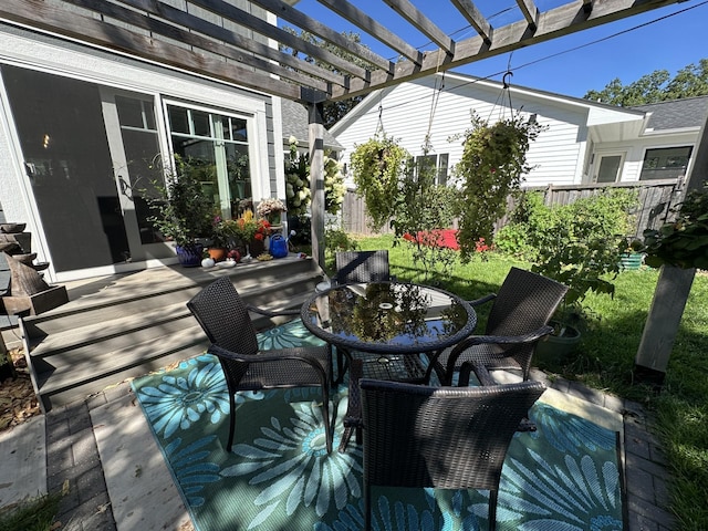 deck featuring outdoor dining area, fence, and a pergola