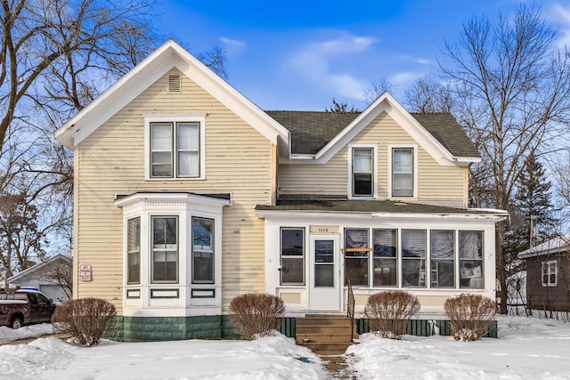 view of front of property with entry steps and roof with shingles