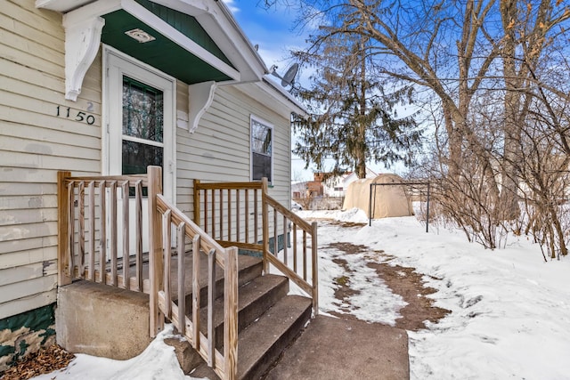 view of snow covered property entrance