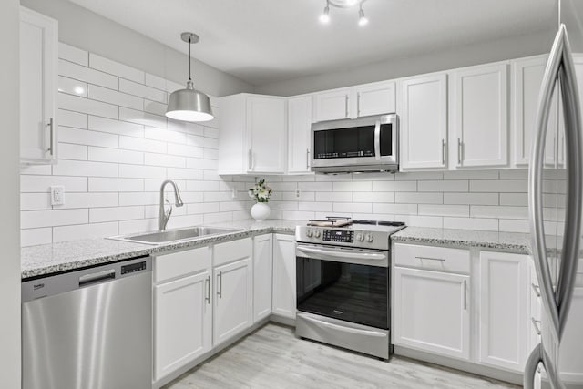 6213 Saint Croix Trl N Unit 102, Oak Park Heights, MN 55082 - kitchen featuring stainless steel appliances, a sink, white cabinetry, and tasteful backsplash