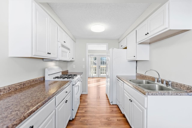 kitchen featuring light hardwood / wood-style flooring, white appliances, french doors, white cabinets, and sink