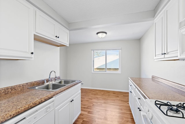 kitchen with sink, white cabinetry, dishwasher, and light hardwood / wood-style floors