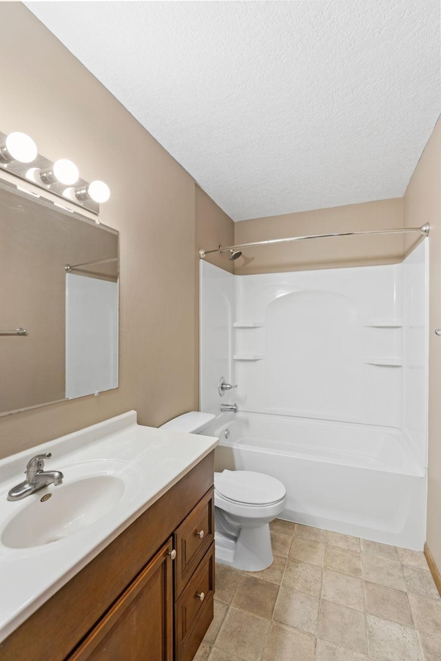 full bathroom with shower / washtub combination, vanity, toilet, and a textured ceiling