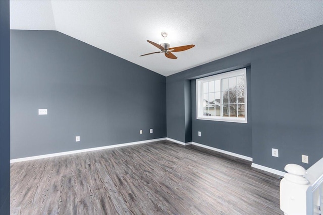 unfurnished room featuring baseboards, lofted ceiling, ceiling fan, wood finished floors, and a textured ceiling