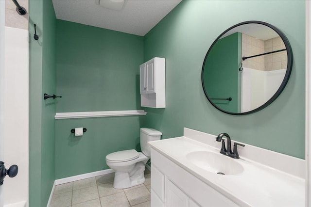 bathroom with a textured ceiling, toilet, vanity, baseboards, and tile patterned floors