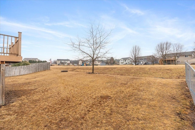 view of yard featuring a residential view and fence