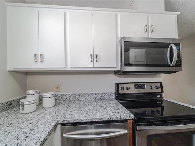 kitchen with white cabinetry and stainless steel appliances