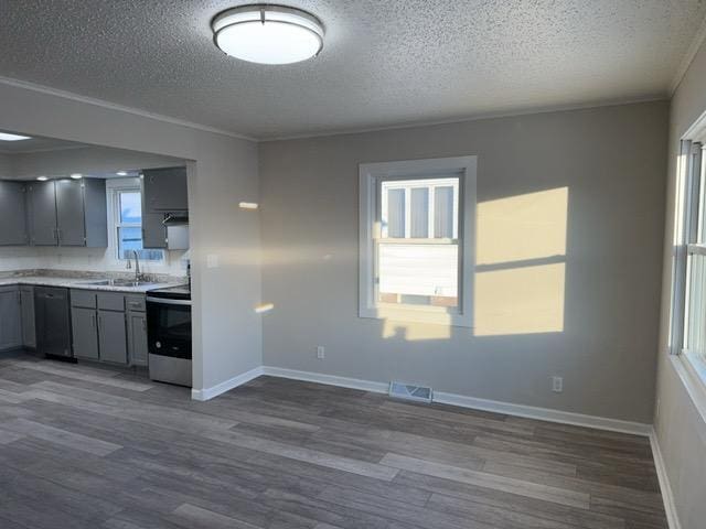 kitchen with stainless steel range with electric cooktop, sink, gray cabinets, dishwasher, and dark hardwood / wood-style floors