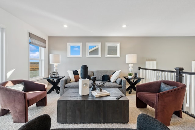 living area featuring recessed lighting and light carpet