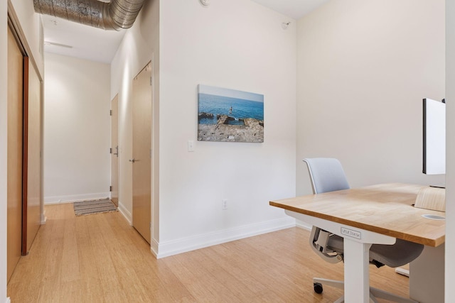 office space with light wood finished floors and baseboards