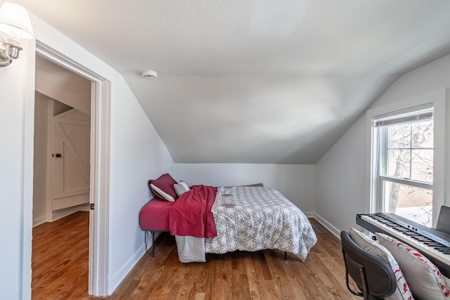 351 Morse Ave, Excelsior, MN 55331 - bedroom featuring vaulted ceiling, wood finished floors, and baseboards